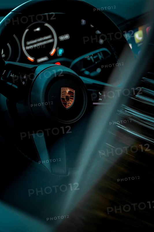 Close-up of a modern steering wheel with speedometer and LED indicators in a car, Porsche Taycan, Deer Carsharing, Calw, Germany
