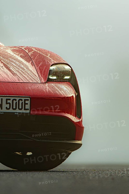 Close-up of a red vehicle with drops of water on the hood, Porsche Taycan, Deer Carsharing, Calw, Germany