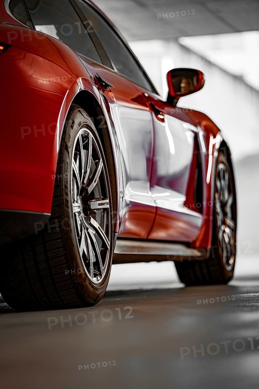 Close-up of a red car in a garage, sporty wheels, shadow games, Porsche Taycan, Deer car sharing, Calw, Germany