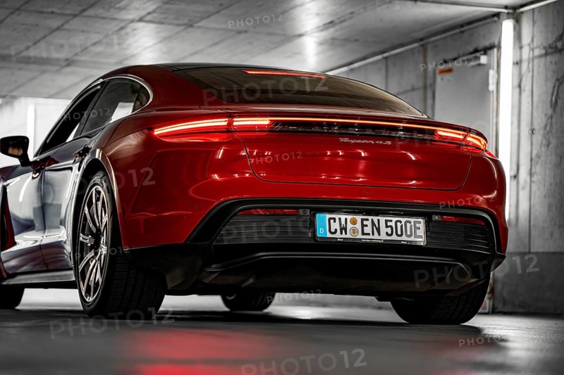 Red car in an underground garage, modern lighting, sporty rear, Porsche Taycan, Deer Carsharing, Calw, Germany