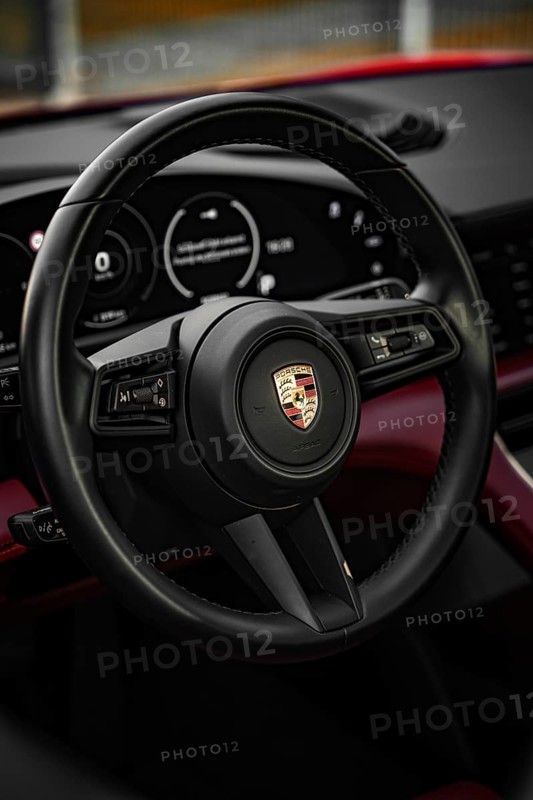 Black steering wheel in the luxurious interior of a Porsche, Porsche Taycan, Deer Carsharing. Calw, Germany