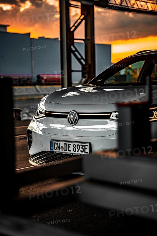 Silver car in industrial area at sunset, VW ID4 electric car, Deer Carsharing, Calw, Germany