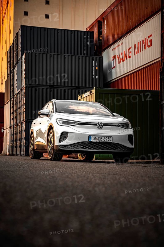 Silver car in front of high-stacked containers, VW ID4 electric car, Deer Carsharing, Calw, Germany
