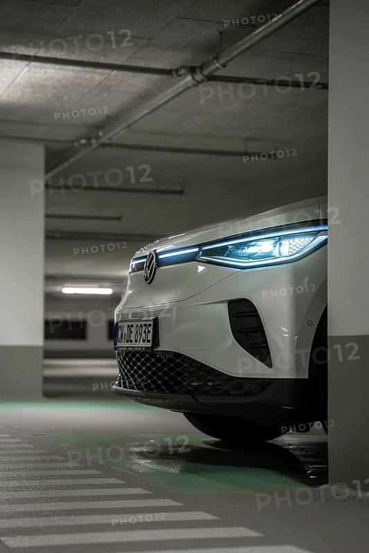A car in an underground garage with headlights on at night, VW ID4 electric car, Deer Carsharing, Calw, Germany