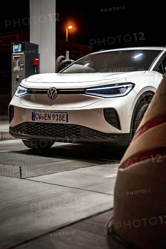 Detailed view of a white Volkswagen at the gas station at night, VW ID4 electric car, Deer Carsharing, Calw, Germany