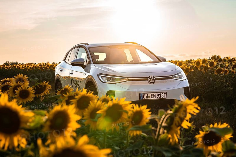 Car between sunflowers at sunset, VW ID4 electric car, Deer Carsharing, Calw, Germany
