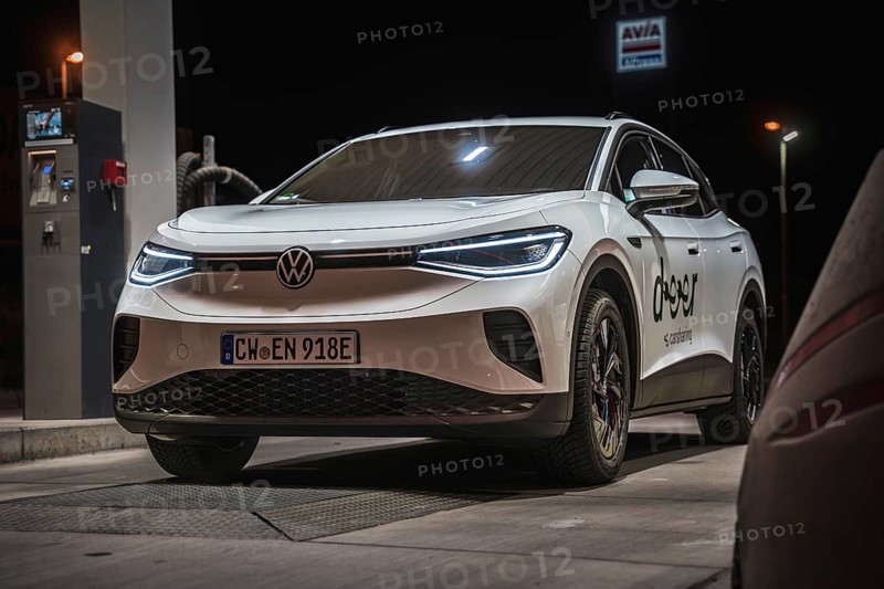 White Volkswagen at a gas station at night, VW ID4 electric car, Deer Carsharing, Calw, Germany