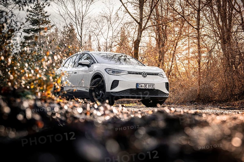 Car in an autumn forest landscape with bare trees, VW ID4 electric car, Deer Carsharing, Calw, Germany