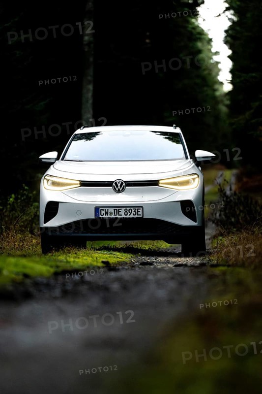 Front view of a car on a dark forest road, VW ID4 electric car, Deer Carsharing, Calw, Germany