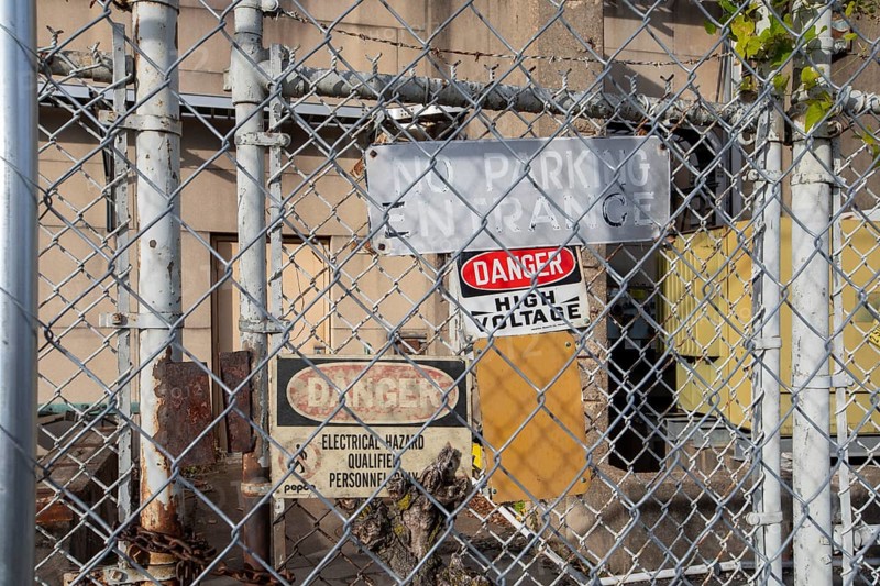 Washington, DC - Signs on a locked gate warn of high voltage and electrical hazards at a Pepco electrical substation at Buzzard Point