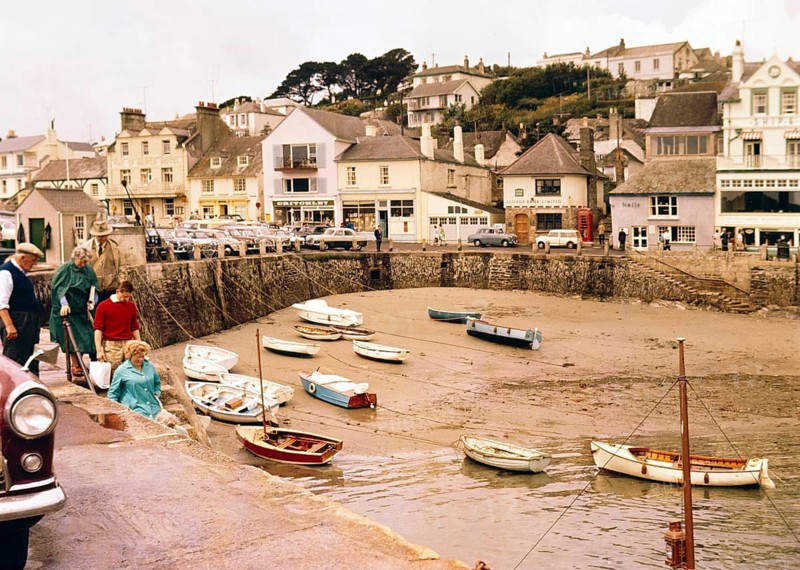 Historic waterfront buildings, boats at low tide in harbour at St Mawes, Cornwall, England, UK, c 1960