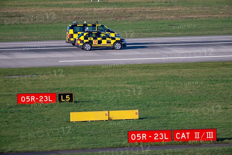 Inspection of runway 05R/23L 3000m main runway south, by Marshall vehicles also called Follow Me vehicle, pilot vehicle, apron supervision, directs aircraft to their parking position, at Düsseldorf Airport, DUS North Rhine-Westphalia, Germany
