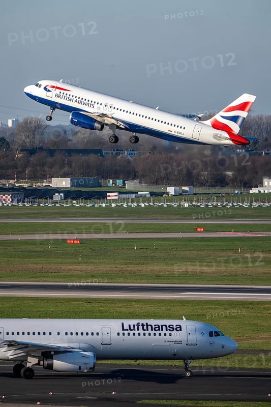 Lufthansa Airbus A321-200 on taxiway for takeoff, British Airways Airbus A320-200 on takeoff, Düsseldorf airport, DUS