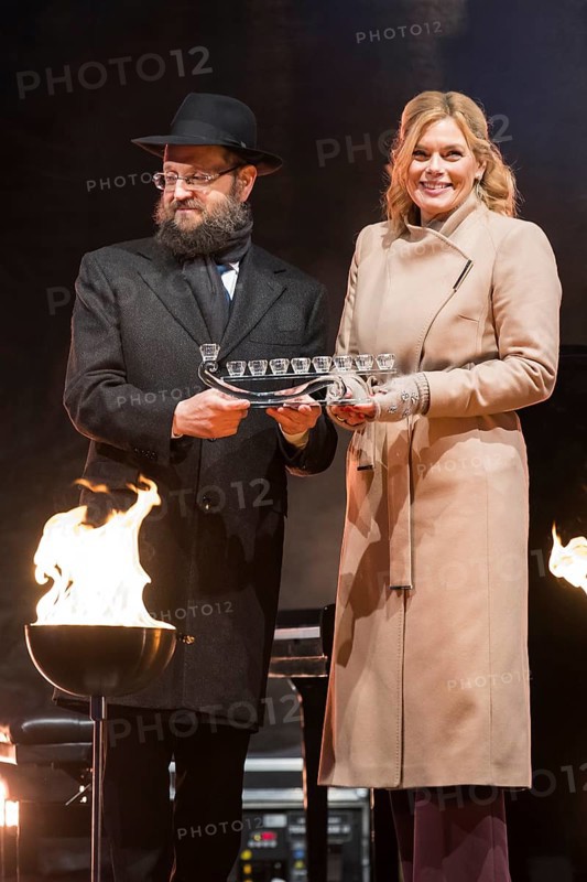 Julia Klöckner (President of the German Bundestag) receives a gift from Yehuda Teichtal (Rabbi of the Chabad-Lubavitch movement) at the lighting of lights to mark 20 years of Hanukkah in front of the Brandenburg Tor, Berlin, 17 December 2025