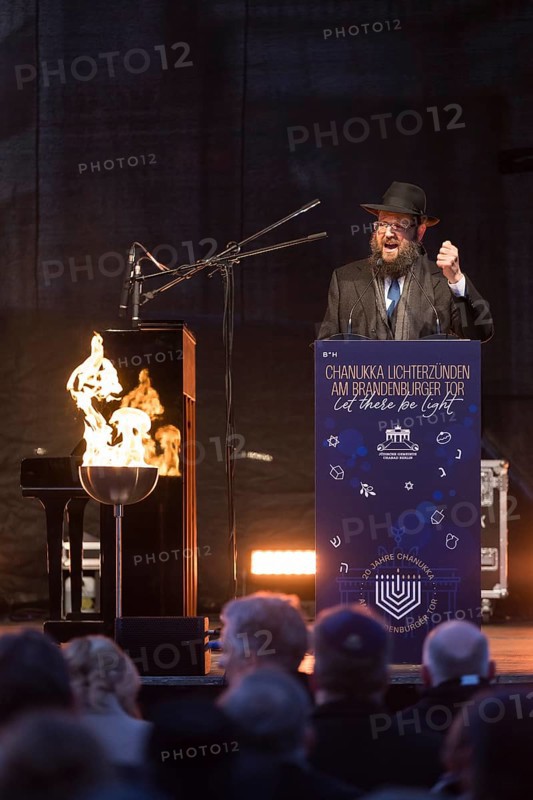 Yehuda Teichtal (Rabbi of the Chabad-Lubavitch movement) speaks at the lighting of lights to mark 20 years of Hanukkah in front of the Brandenburg Tor tor, Berlin, 17 December 2025