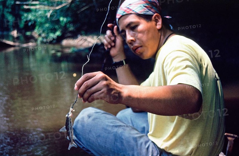 Man caught fish to be used as bait for piranhas, Rio Yanayacu, Amazon region near Iquitos, Peru, South America, September 1997, vintage, retro, old, historic