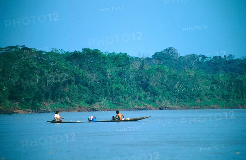 Boat traffic on the Rio Tambopata near Puerto Maldonado in the Amazon Basin, Peru, South America, September 1997, vintage, retro, old, historic