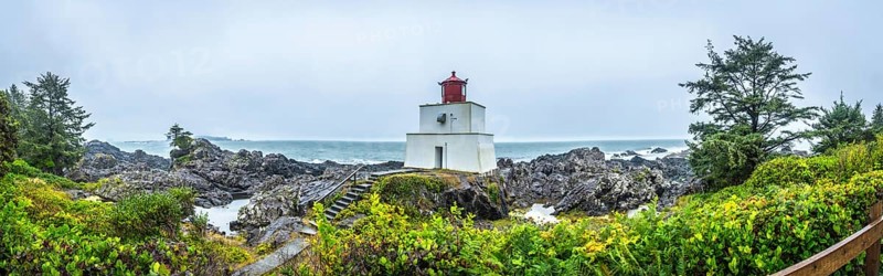 Panoramic view of amphitrite point lighthouse on the rocky ucluelet coast of vancouver island, british columbia, guiding vessels through the misty pacific ocean