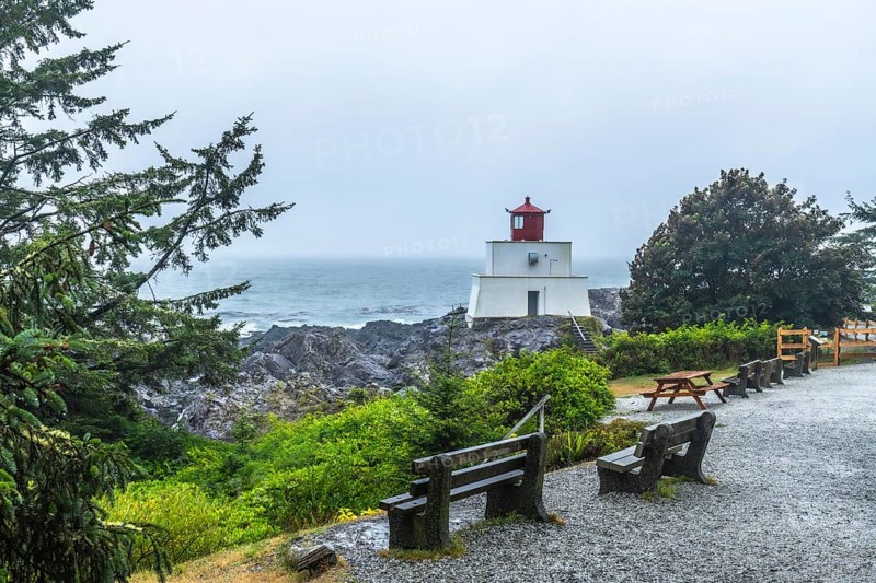 Amphitrite point lighthouse rising on the rocky ucluelet coast of vancouver island, british columbia, offers a safety beacon for vessels navigating the foggy pacific ocean