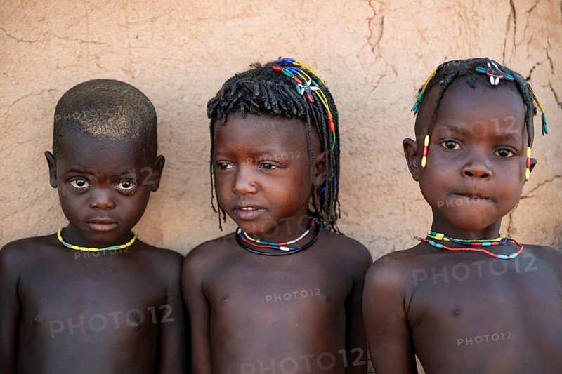 Three children in the village, the Hakaona tribe also Havakona or Hakawona, near Opuwo, Kunene, Namibia