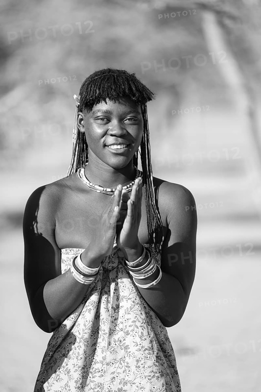 Black and white, traditional dance, brightly decorated woman of the Hakaona tribe dance, also Havakona or Hakawona, near Opuwo, Kunene, Namibia