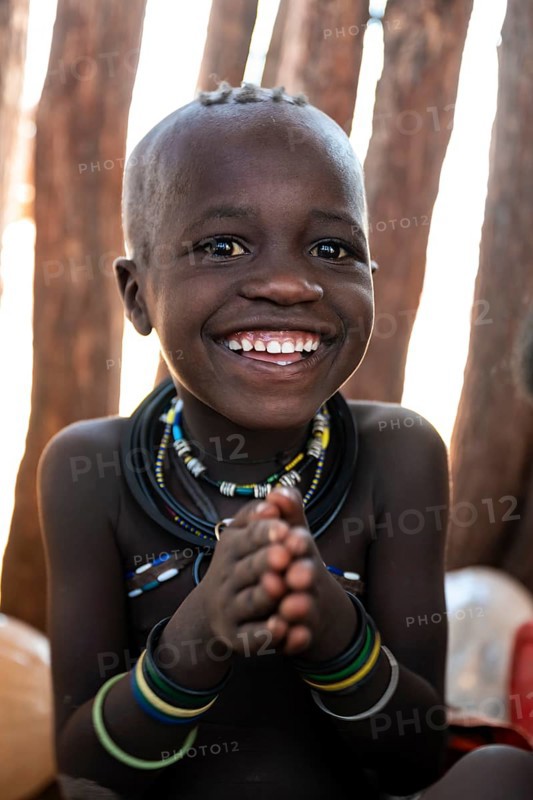 Portrait, grinning Himba child, traditional Himba village, Kaokoveld, Kunene, Namibia