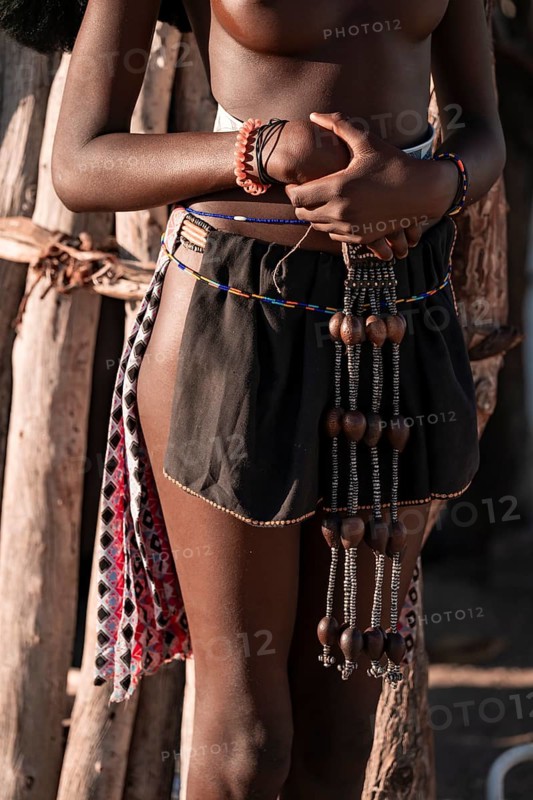 Detail, jewelry and clothing, young Himba woman, traditional Himba village, Kaokoveld, Kunene, Namibia