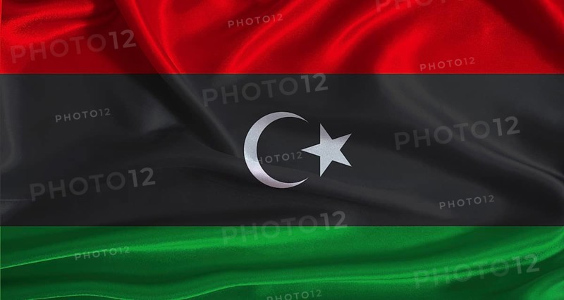 Libya flag with cloth textured background. National flag of Libya with realistic texture