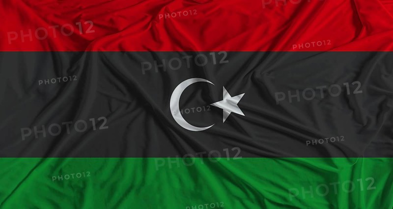 Libya flag with fabric texture background. National flag of Libya with cloth texture