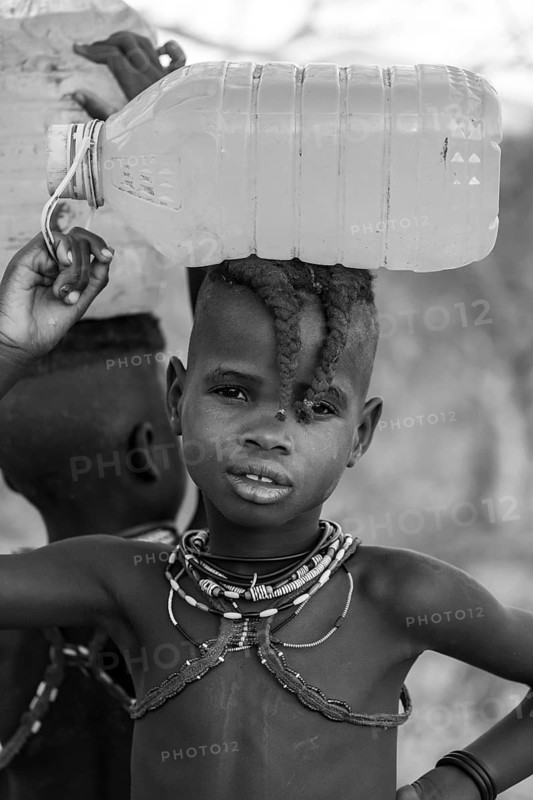 Black and white, Himba child fetches water, carries water bottle, traditional Himba, Kaokoveld, Kunene, Namibia