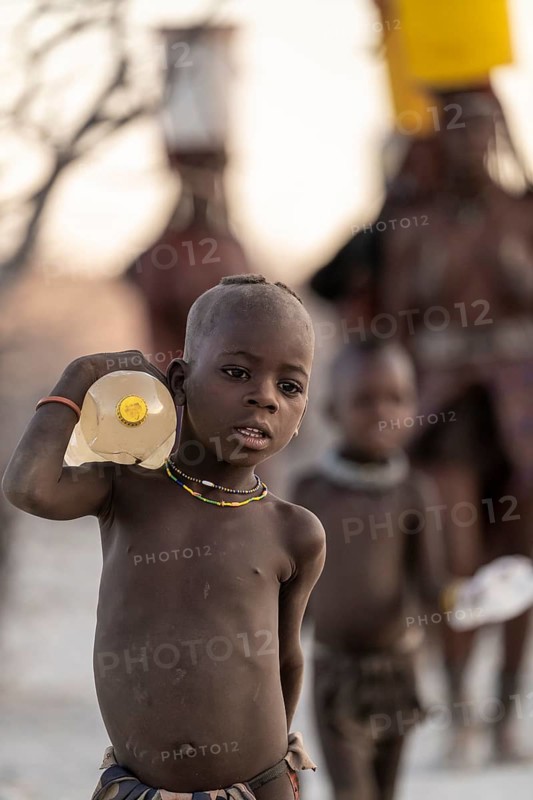 Himba children fetches water, carries water bottle, traditional Himba, Kaokoveld, Kunene, Namibia