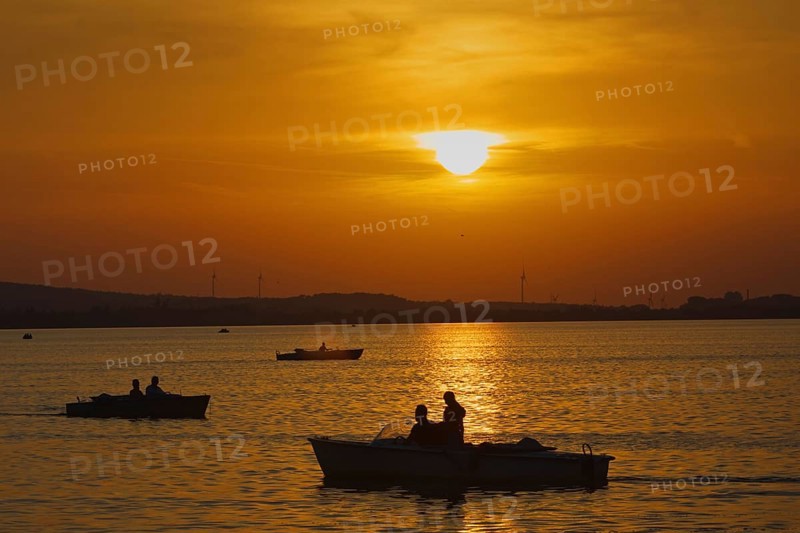 Boats sailing on a lake at sunset, romantic evening mood, Steonhude Steinhuder Meer