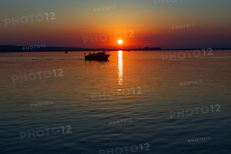 Sunset over the Steinhuder Meer with boat at dusk, quiet scene, Steinhude