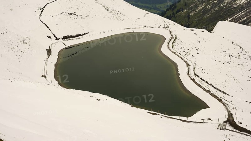 Another onset of winter in May, Riezler Alpsee, an artificially created lake, snow pond, feeds the snow cannons that completely snow the slopes of the Fellhorn and Kanzelwand cable cars, Allgäu Alps, Vorarlberg, Austria