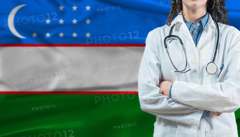Medical professional on Uzbekistan flag. Healthcare and wellness in Uzbekistan, Concept