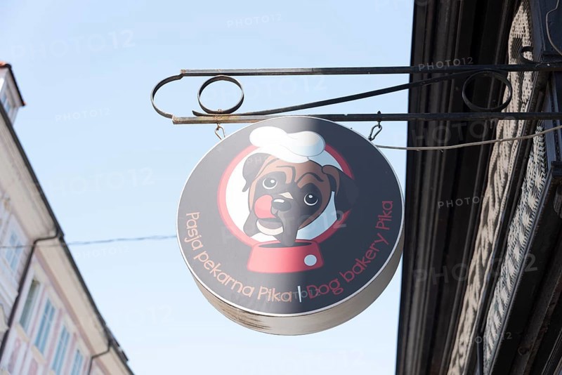 Round cantilever sign of the Pika dog bakery in the old town of Ljubljana, Slovenia