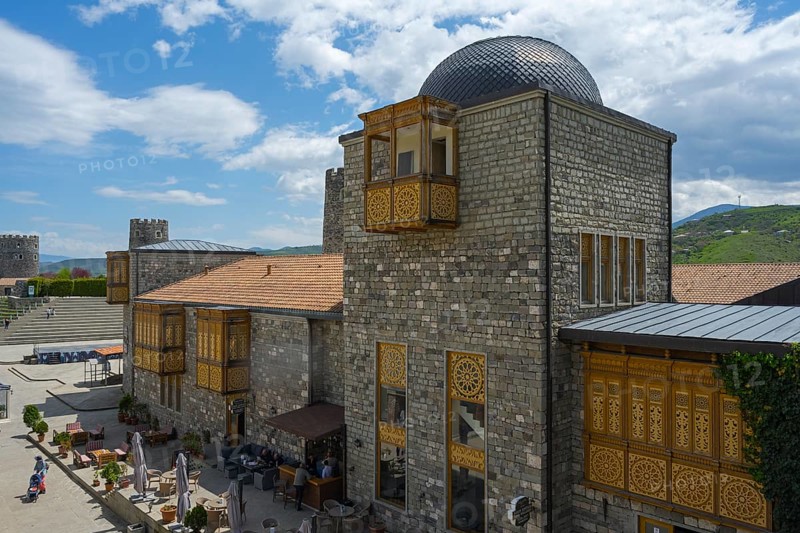 Buildings with stone walls, decorative wooden elements and domed roof under a blue sky, Rabati Fortress, Akhaltsikhe, Samtskhe-Javakheti region, Samtskhe-Javakheti, Georgia
