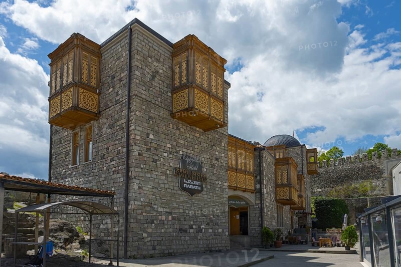 A historic building with intricately decorated wooden balconies against a cloudy sky, Rabati Fortress, Akhaltsikhe, Samtskhe-Javakheti region, Samtskhe-Javakheti, Georgia