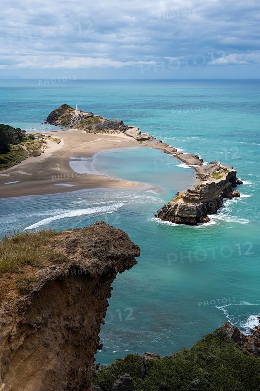 Deliverance Cove and Castlepoint Lighthouse, Castle Rock views, rocks, ocean. Castlepoint, Wairarapa Coast, Wellington Region, North Island, New Zealand