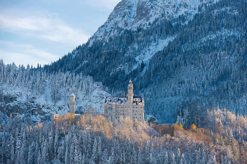 Romantic Neuschwanstein Castle in winter surroundings, nestled in snow-covered mountain landscape, Schwangau, Ostallgäu, Allgäu, Bavaria, Germany