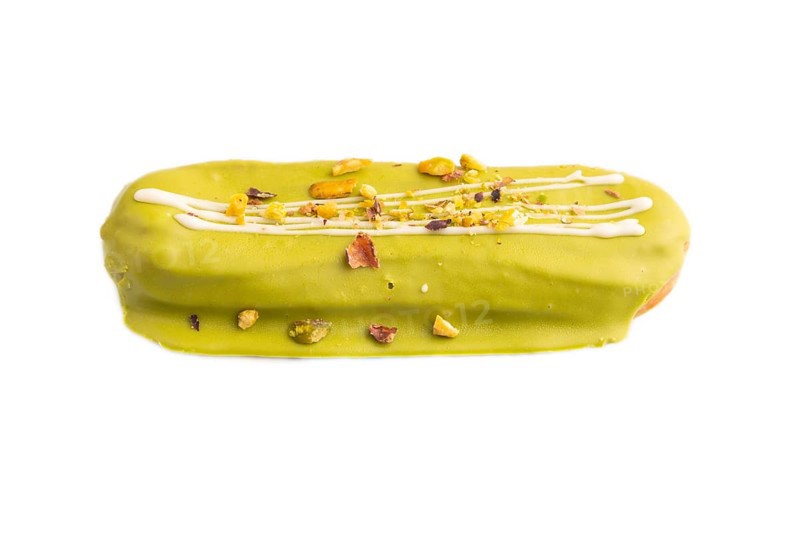 Glazed green Eclair on brown concrete isolated on white, side view, close up