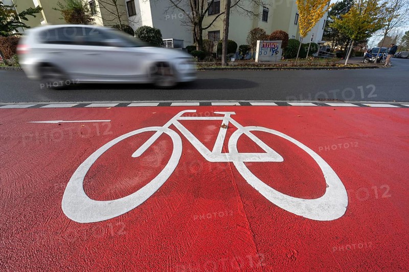 Car passing by the marked bicycle path, Röthebach, Mittelfranken, Bavaria, Germany