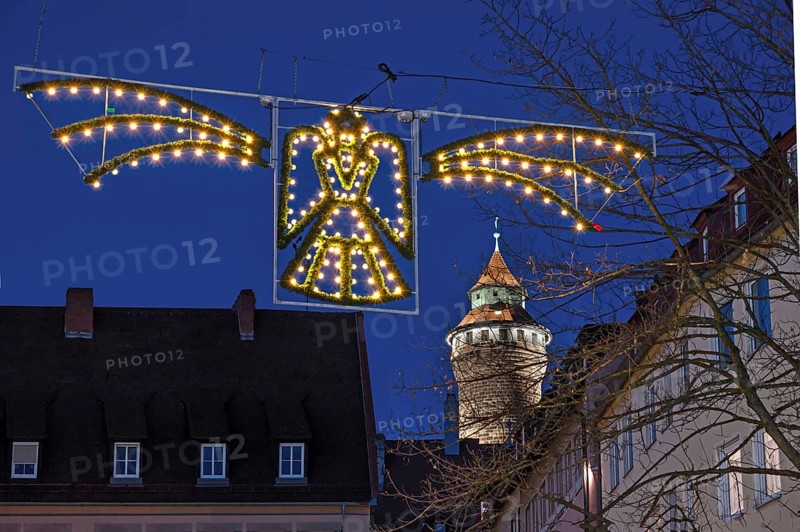 Historic Sinwell Tower illuminated in the evening, Christmas angel glowing in front for Advent, Old Town, Nuremberg, Middle Franconia, Bavaria, Germany