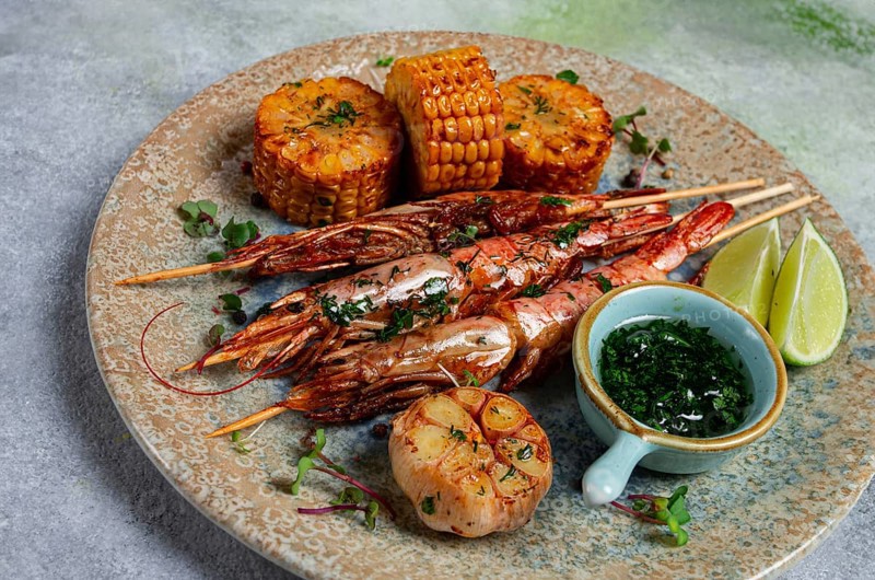 Langoustines on skewers, shrimp kebab, with fried corn, spices and herbs, homemade, no people