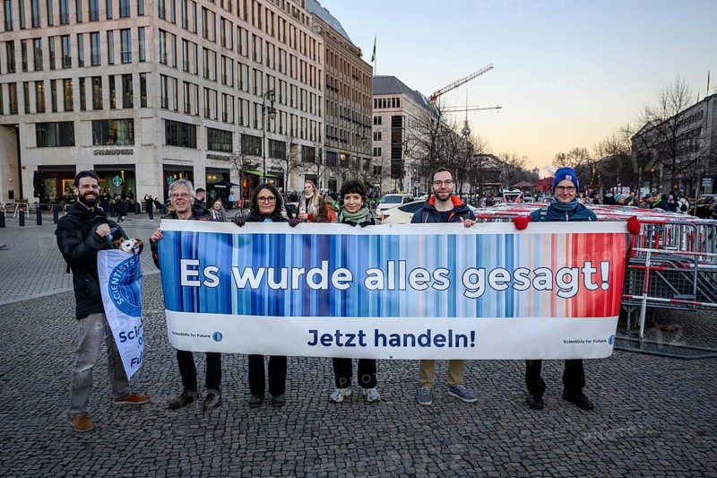 Banner It's all been said! Act now! by Scientists for Future at Fridays for Future rally on 10 years of Paris Agreement and 7 years of Fridays for Future. Pariser Platz, Berlin, 12.12.2025