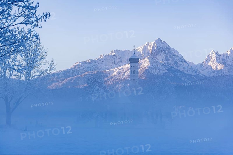 Snowy mountain landscape with St. Coloman pilgrimage church in the foreground and foggy background, Schwangau near Füssen, Ostallgäu, Allgäu, Bavaria, Germany