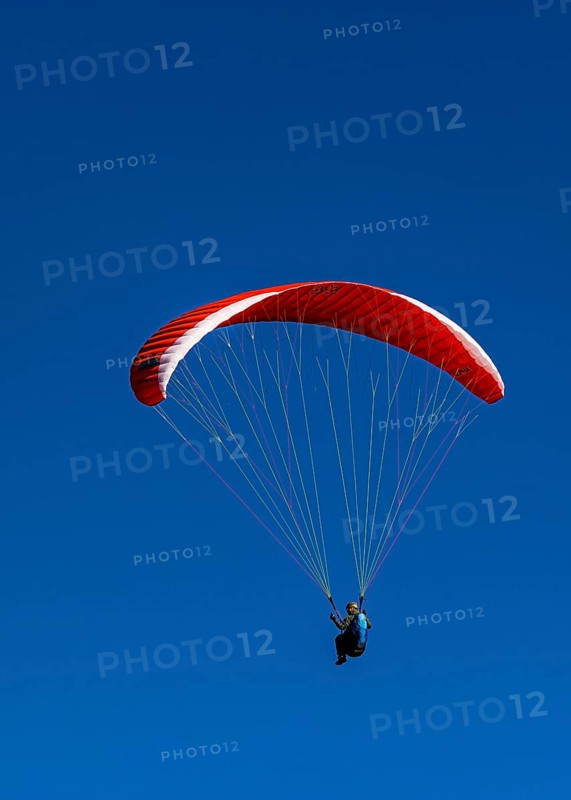 Paragliders against a blue sky, Val d'Anniviers, Valais Alps, Canton of Valais, Switzerland