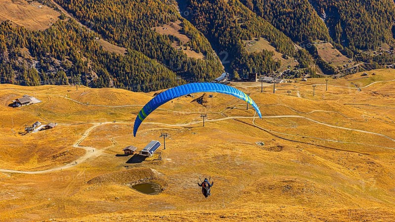 A paraglider takes off from the summit of Corne de Sorebois, Val d'Anniviers, Valais Alps, Canton of Valais, Switzerland
