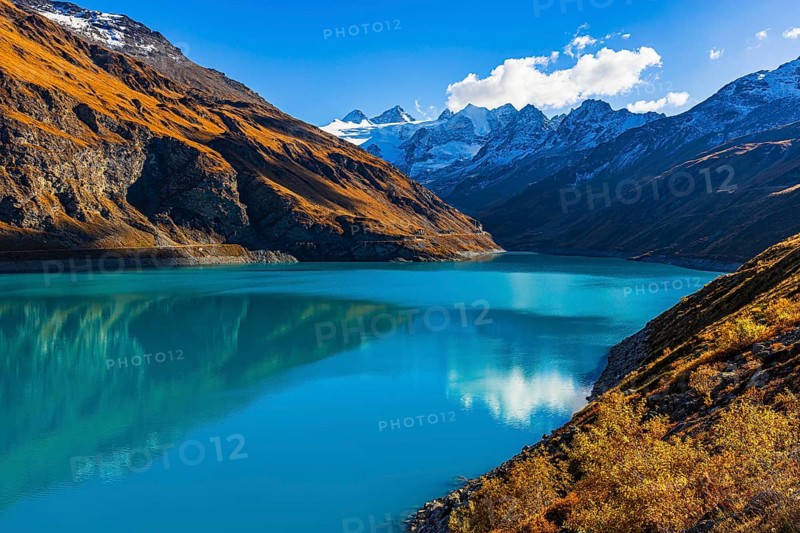 The Lac de Moiry reservoir, with the snow-capped peaks of the Grand Cornier, Tete Blanche and Pointe Moiry mountains, Val d'Anniviers, Valais Alps, Canton of Valais, Switzerland