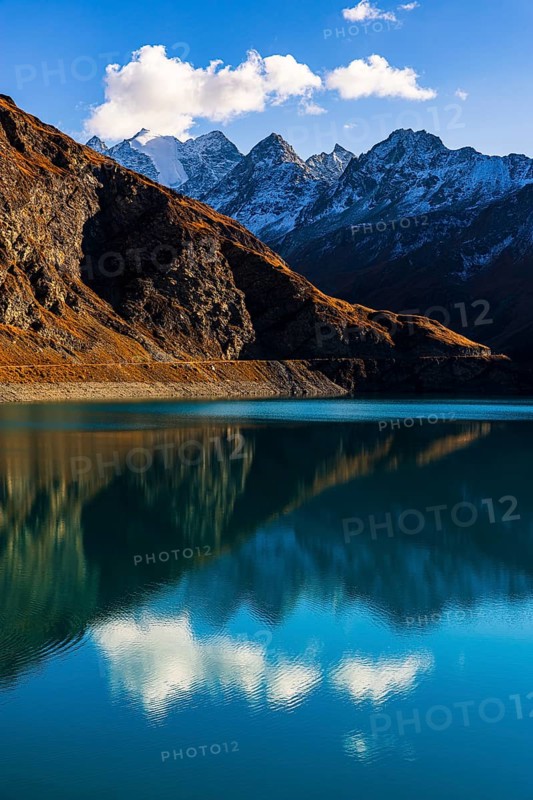 The turquoise Lac de Moiry reservoir, behind the peaks of the Grand Cornier, Tete Blanche and Pointe Moiry mountains, Val d'Anniviers, Valais Alps, Canton of Valais, Switzerland
